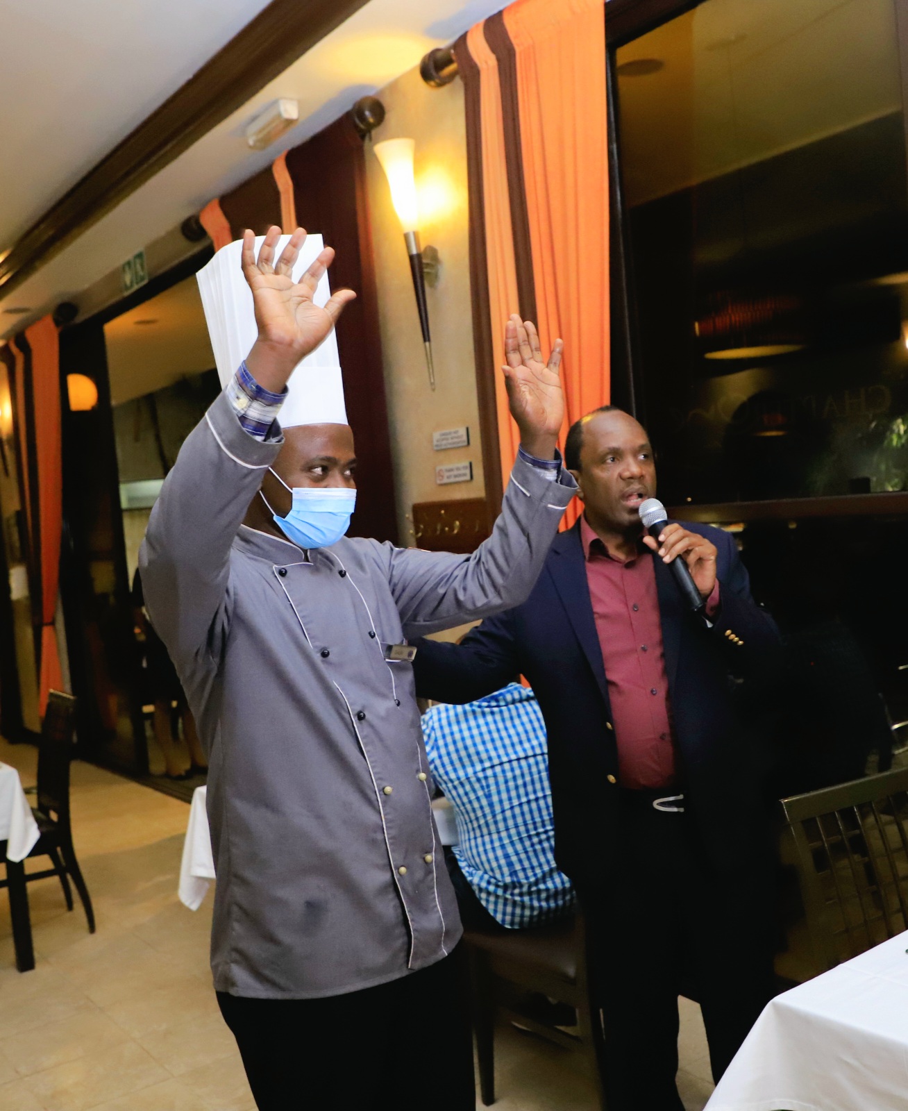 The Simba Group Chairman, Patrick Bitature introducing the head chef behind the tasty cuisine enjoyed during the Swahili Night at Protea Kampala