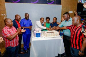 Simba Group Staff along with Patrick Bitature, the Board Chairman cutting cake to celebrate the end of a successful year